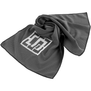 A grey cooling towel with a textured design and logo, elegantly draped in a loose arrangement.