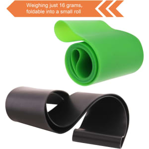 A green and black latex-free TPE fitness resistance band, rolled into a compact shape for easy storage.