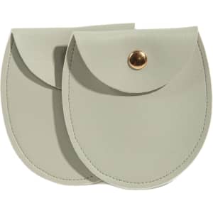 A set of two oval-shaped, light grey PU leather jewelry pouches with a gold-tone snap closure.