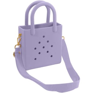 A mini beach bag in lavender with handles and a detachable strap, featuring holes and a simple design.