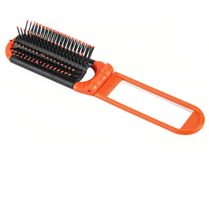 A folding hair brush with mirror in orange and black, featuring bristles and a compact design.