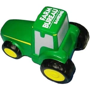 A green tractor-shaped stress reliever with yellow wheels and a branding logo on top.