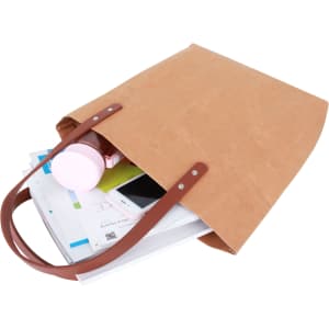 A brown washable kraft paper bag with a PU handle, filled with assorted items, including a drink bottle and papers.