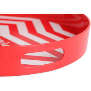 A red serving tray with a zigzag pattern and two cut-out handles. It has a glossy finish.