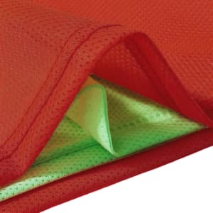 A reversible training bib featuring red on one side and vibrant green on the other, made from 100% polyester mesh.