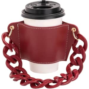 A drink bottle holder in burgundy leather, featuring an acrylic strap and a cup secured within.
