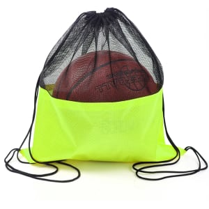 A bright yellow drawstring mesh backpack holding a basketball, with black mesh detailing and drawstrings.