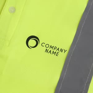 A bright yellow unisex polo shirt with reflective grey stripes and a logo on the front.