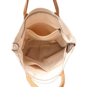 An interior view of a vintage style canvas bag in cream with tan handles and multiple compartments.