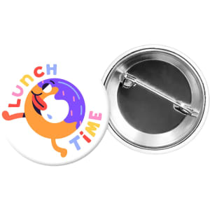 A round button badge featuring a colourful design with a cartoon doughnut and the words "LUNCH TIME." It has a metal backing.