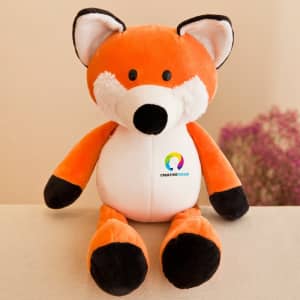 An orange and white fox plush toy with black details and a branding logo on its chest.