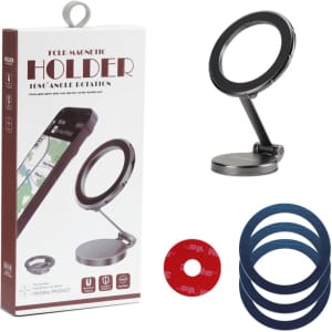 A black magnetic car phone holder with a folding design, accompanied by coloured adhesive discs, displayed in its packaging.