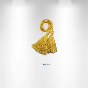 Two yellow tassels are neatly tied together, featuring long, frayed ends. The image has a simple background and a logo.