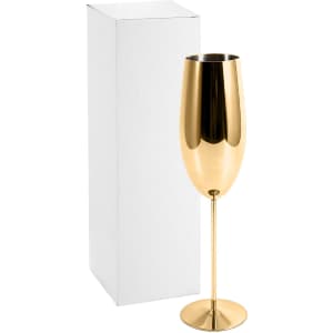 A stainless steel champagne flute in a shiny gold finish, next to a plain white box.
