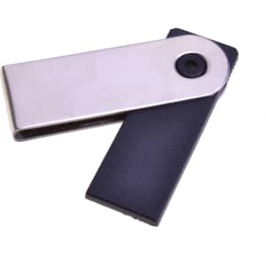 A silver and black Mini Festin flash drive with a sleek design and a circular button.