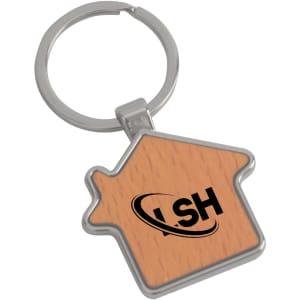 A wooden keyring shaped like a house with a silver metal frame and a logo on the wooden surface.