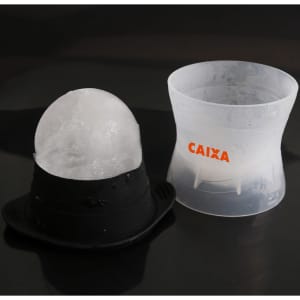 A whisky ice ball mould featuring a black base and clear container, designed for making spherical ice cubes.