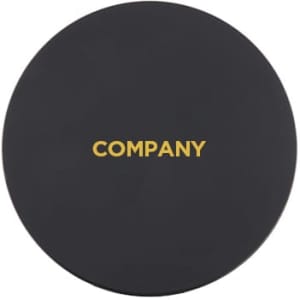 A black wireless charger with a round shape and a gold logo in the centre.
