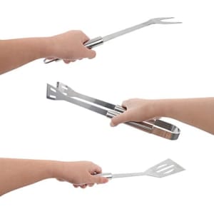 Three pieces of stainless steel barbecue tools held in hands, including a fork, spatula, and tongs, with a pouch present.