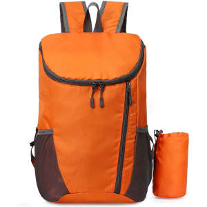 An orange packable travel backpack with grey accents, featuring a zippered front pocket and a compact carry pouch.