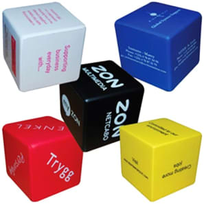A collection of cube-shaped stress relievers in black, blue, red, yellow, and white, featuring various logos and text.