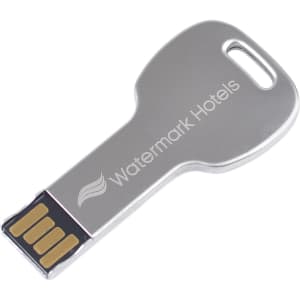 A round metallic key-shaped flash drive with a silver finish and an embedded branding logo.