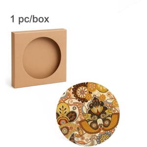 A round ceramic coaster featuring a vibrant, floral pattern, with a simple box for packaging in the background.