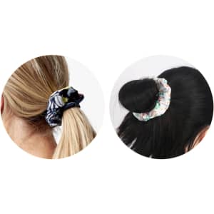 Two hair scrunchies in different styles: one patterned in black and the other in white with floral designs.