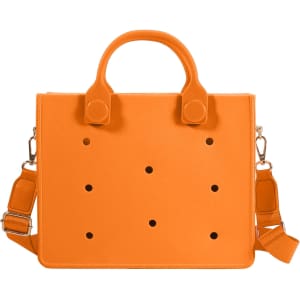 An orange tote bag with holes, featuring both handles and a detachable shoulder strap. It has a logo.