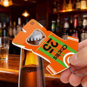 A drink bottle opener keyring shaped like a sport jersey in orange with green stripes and a logo.
