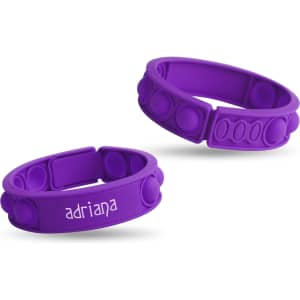 Two purple silicone wristbands featuring raised bubbles and a logo, designed as a fidget novelty item.