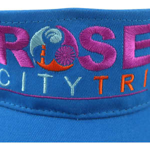 A blue sport visor featuring embroidered text and a logo. It has a wide brim for sun protection.