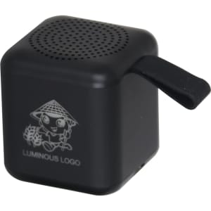 A black lighting cube Bluetooth speaker with a small handle and a logo on the side.