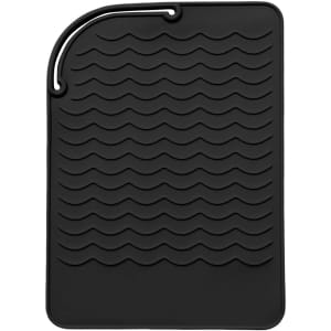 A black silicone hair straightener pad with a textured wave design and a hanging loop.