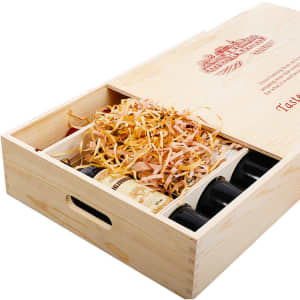 A wooden gift box in natural wood finish, holding six wine bottles with decorative packing straw inside.