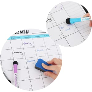 A magnetic calendar planner featuring a whiteboard surface, black and purple markers, and an eraser.