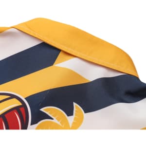 A close-up of a women's button-up shirt featuring yellow, blue, and white colours with a Hawaiian print and collar.