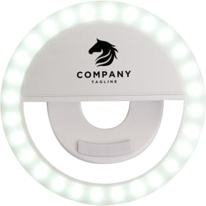 A white ring selfie light featuring a logo at the top and multiple LED bulbs around the edge.
