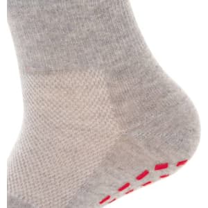 A grey sock featuring a textured design and red grips on the sole. It has a branding logo.