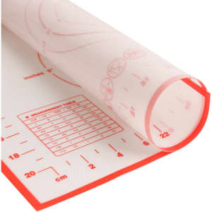 A silicone pastry mat in white with red edges, featuring measurement markings and a branding logo.