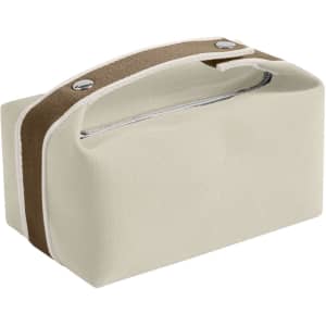 A portable canvas cosmetic bag in cream colour with a brown strap and silver accents. It has a zippered opening.