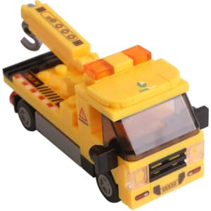 A yellow building block toy truck with a crane and safety markings, featuring a logo on the side.
