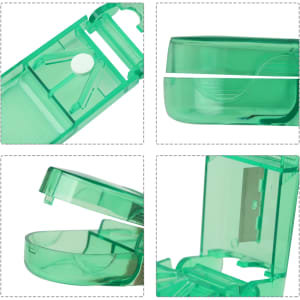 A green pill box with a cutter, featuring a transparent design and a hinged opening mechanism.