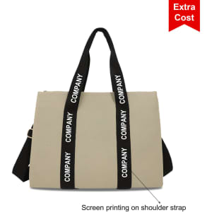 A beige canvas grocery shopping bag featuring black shoulder straps with screen printing and a logo.