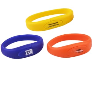 Three oval silicone wristbands in yellow, blue, and orange, each featuring a logo or branding.
