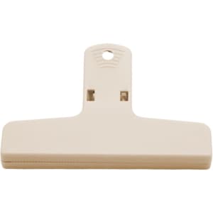 A beige plastic magnetic clip with a flat surface and a hanging hole at the top, featuring a small logo.