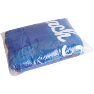 A blue cotton poncho towel packed in clear plastic, featuring a logo. Suitable for beach or surf activities.