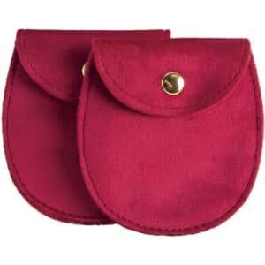A pair of oval velvet jewelry pouches in rich burgundy with gold button closures.