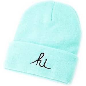A mint green knitted beanie with a black embroidered message and a logo on the band.
