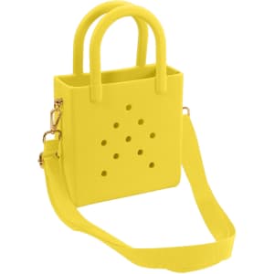 A yellow mini beach bag with holes, featuring dual handles and a detachable strap. It has a simple, modern design.